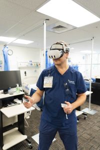Bushnell University nursing student uses virtual reality technology in a clinical simulation lab to practice healthcare skills.