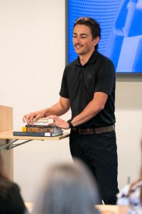 Student delivers a presentation using historical texts during a classroom discussion at Bushnell University.
