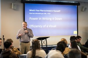 Male professor leads a workshop for students on leadership