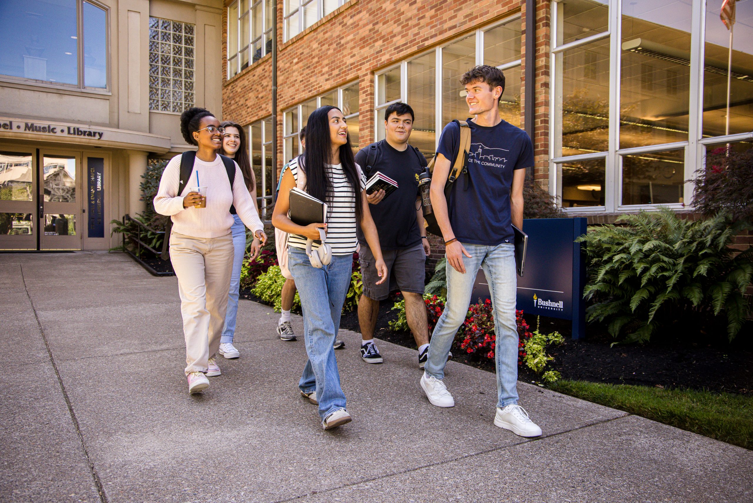 A group of students walk together on Bushnell University campus