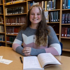 Headshot of a female accounting student working in a library