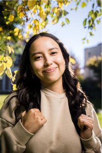Sunny headshot of female student with backpack